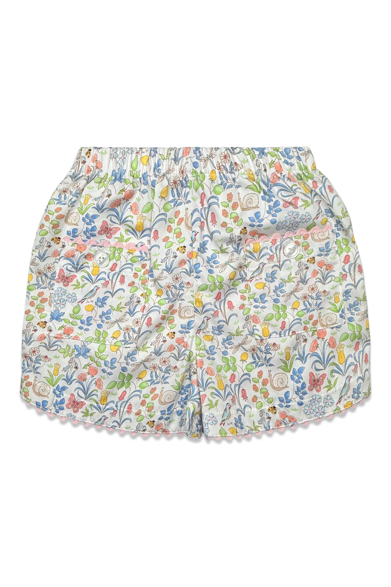 A pair of girl's shorts featuring an all-over multicolor floral and botanical print on a white base, finished with a delicate scalloped edge.